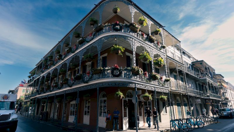 A multi-story building with balconies and potted plants